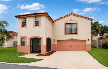 Mediterranean-style exterior featuring a stucco finish and terracotta roof tiles