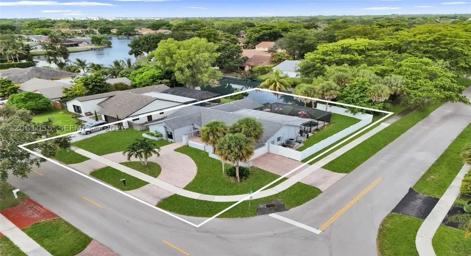 Corner lot wit pool, lake view and two driveways
