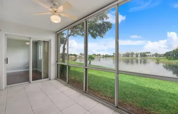 Enclosed and screened in back patio on lake