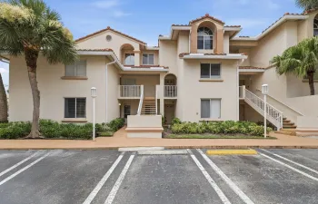 Mediterranean-inspired architecture featuring a stucco exterior and terracotta-style roof tiles