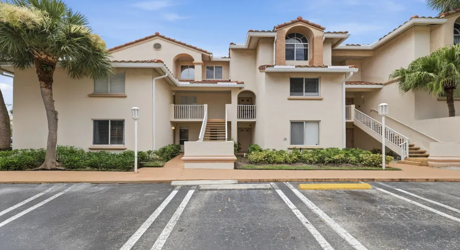 Mediterranean-inspired architecture featuring a stucco exterior and terracotta-style roof tiles