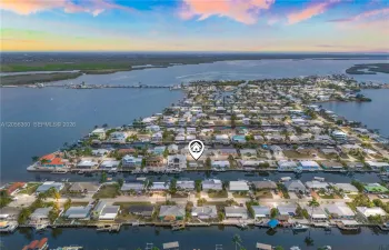 Bird’s-eye perspective of the charming island community, canals, and Gulf access.
