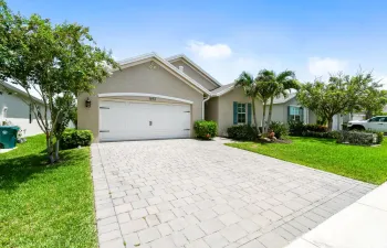 Built in 2021, this beautifully upgraded DR Horton Neuville model offers a desirable triple-split floor plan on an oversized lot. The CBS stucco home features impact-resistant windows and doors, decorative shutters, a two-car garage with a paver driveway, and mature tropical landscaping for exceptional curb appeal. Inside, wood-look tile flooring flows throughout the home, complemented by quartz countertops, upgraded wood-look cabinetry, a spacious pantry, and upgraded ceiling fans. Step outside to your private backyard retreat featuring a heated saltwater pool and a custom screened enclosure with panoramic picture-window screening—perfect for relaxing or entertaining year-round.