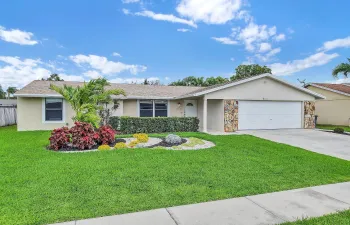 FRONT OF HOME WITH 2 CAR GARAGE & CUSTOM LAWN