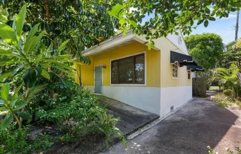 Yellow exterior siding with white foundation