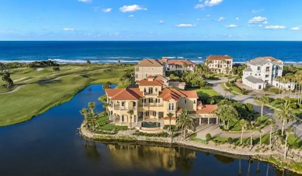 Located behind the exclusive North Gate of Hammock Dunes, this extraordinary Mediterranean estate occupies one of the community’s most iconic peninsula homesites capturing panoramic Atlantic Ocean, lake, and championship golf course views, including sweeping vistas across the 6th and 7th fairways.