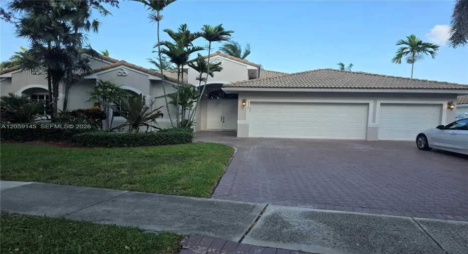 Front view of home and three car garage