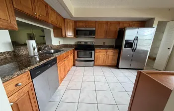 Modern Eat-In Kitchen Featuring Granite Counter Tops and Stainless Steel Appliances