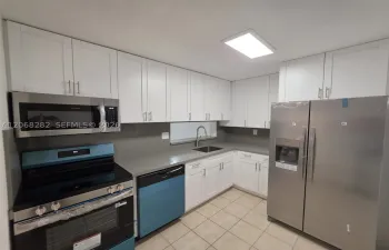 Brand new kitchen with new white cabinets and stainless steel appliances