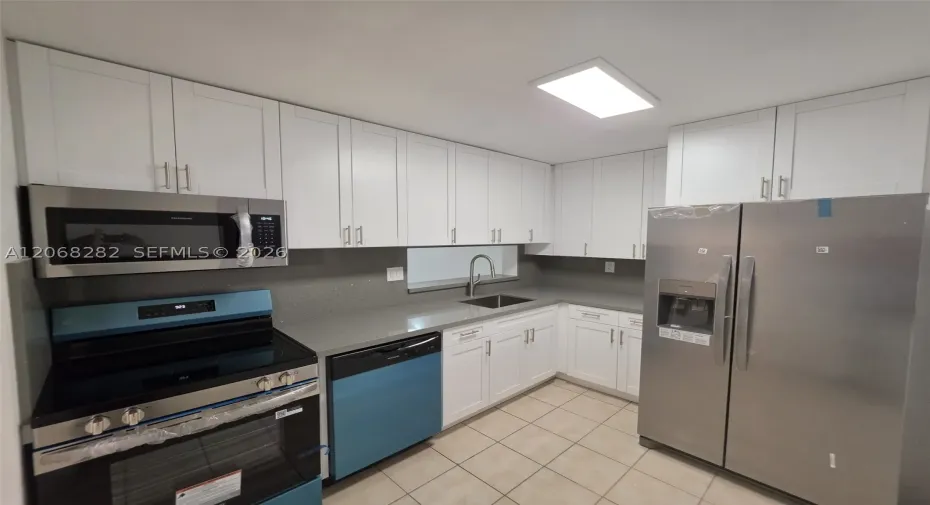 Brand new kitchen with new white cabinets and stainless steel appliances