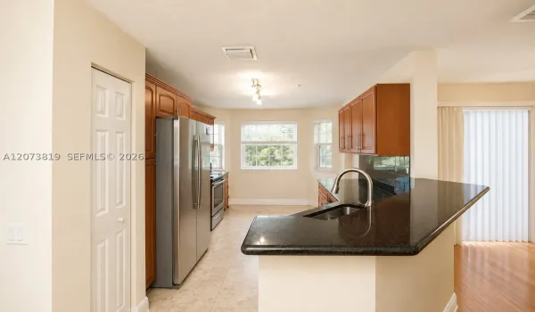 American style open kitchen with bar counter for dining.