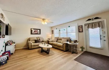 Lovely Living Area with Upgraded Flooring & Designer Window Treatments