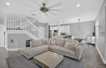 Oversized Great Room with impact windows, recessed lights, half bathroom, garage access, and renovated kitchen.