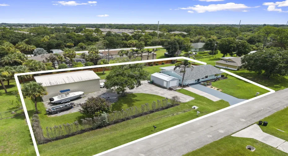 Double lot includes home, detached workshop, storage shed, additional boat/ vehicle parking, and firepit patio.