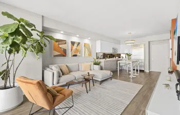 Open-concept living space featuring wood-finish flooring, recessed lighting, and a modern kitchen