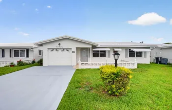 Home facing south with attached garage and wide driveway.