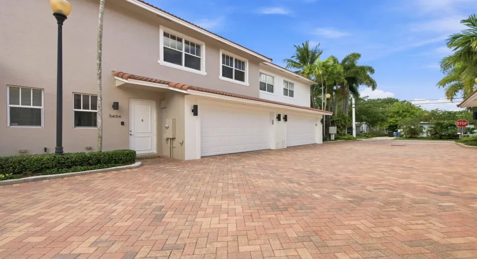 Brick-paver motor court leading to the residence and private two-car garage.