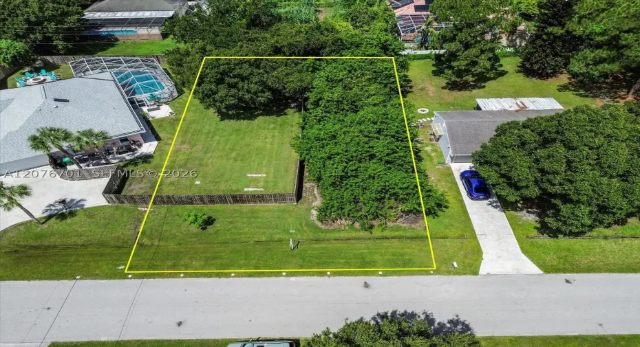 Property line is approximately where the yellow North & South lines are.