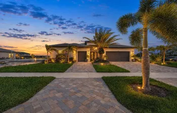 Contemporary single-story residence featuring a tile roof and stucco exterior