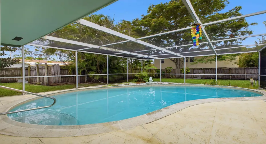 Expansive screened lanai with plenty of space for outdoor dining and lounging