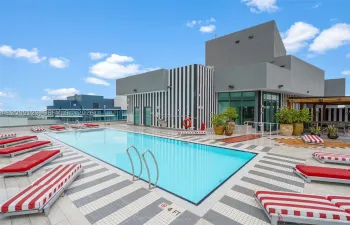 Rooftop pool with signature red-striped chaise lounges - elevated relaxation at SLS Brickell Dua.