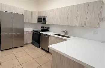 quartz countertop and backsplash, slow close cabinets