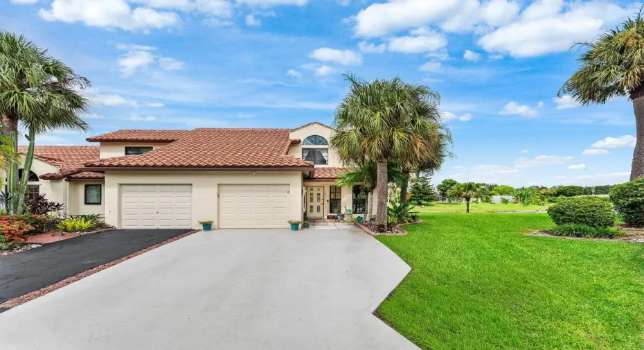 Mediterranean-style architecture featuring a tile roof, stucco exterior, and two-car garage