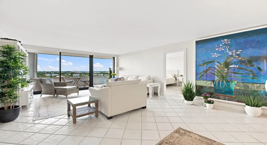 Expansive living area featuring light-toned tile flooring throughout