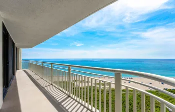 The covered oceanfront balcony opens to wide Atlantic Ocean and Singer Island beach views from this 15th-floor residence.