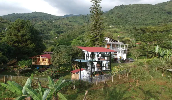 The property features a main residence, three glamping units, aprivate lake, and a storage room.