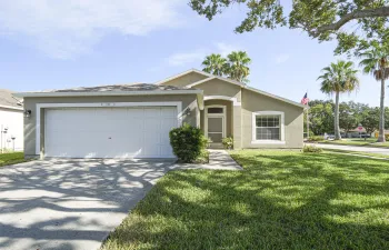 Single-story residence featuring stucco exterior, an attached garage, and a concrete driveway