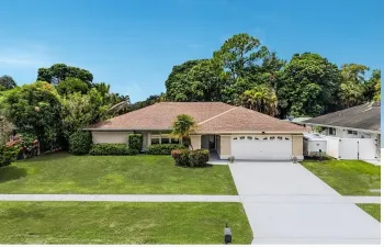 Single-story residence featuring a shingle roof, an attached two-car garage, and a concrete driveway