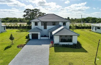 Front view including 2 single car garage