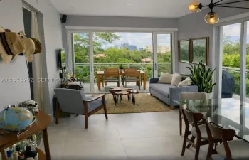 large living room dining room combo with large double slider impact glass doors
