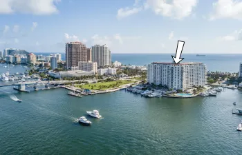 Waterfront high-rise building featuring a marina, outdoor swimming pool, and proximity to ocean and cityscape