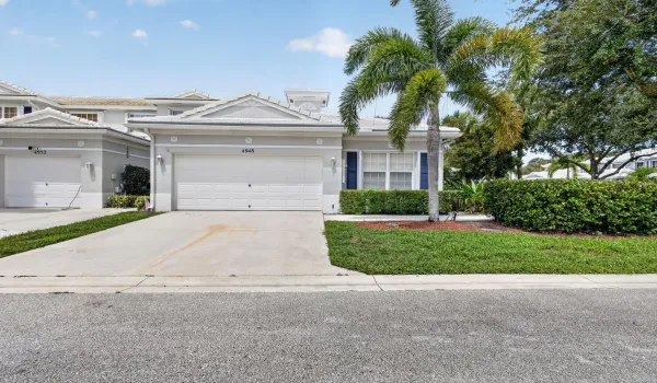 Attached garage with a paved driveway