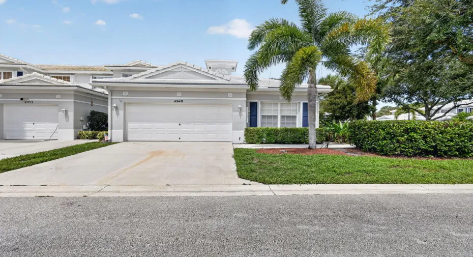 Attached garage with a paved driveway