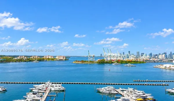 Breathtaking open balcony view of Biscayne Bay, marina, and Miami Beach skyline