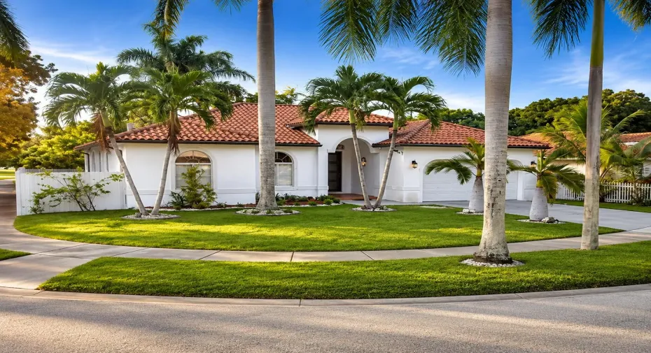 Mediterranean home with palm-lined yard
