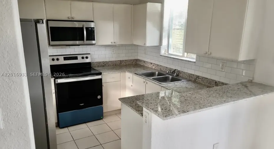 stainless steel appliances and granite counter top. Open Kitchn with Family room (not showing in this picture).