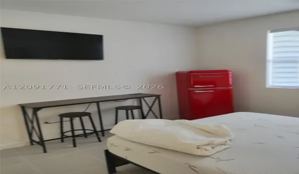 TV in front of the bed.