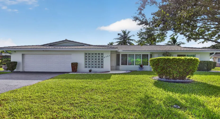 Single-story residence featuring a two-car garage, , and a tile roof