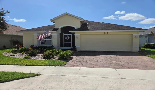Front yard- screened in porch. 2 car garage - beautiful landscape and curb appeal.