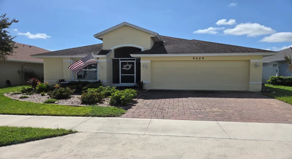 Front yard- screened in porch. 2 car garage - beautiful landscape and curb appeal.