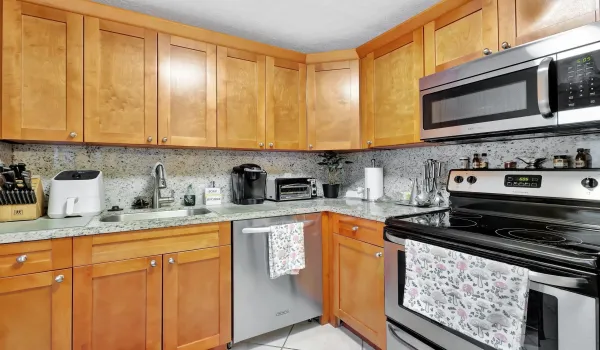 Beautiful wood cabinetry-granite countertops and full backsplash-stainless appliances.