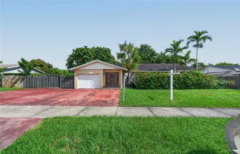Spacious driveway with a metal gate