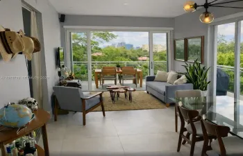 large living room dining room combo with large double slider impact glass doors