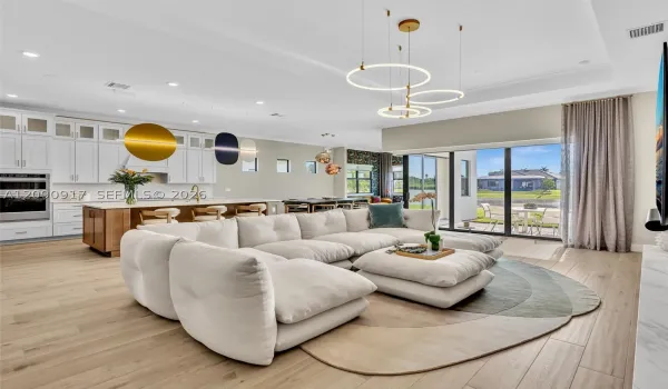Living room, dining area and sun room look out to the lake