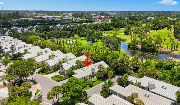 Wide aerial view showcasing the home, surrounding neighborhood, and nearby recreational areas.