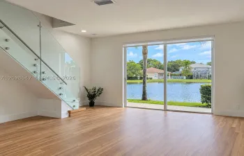 Light-filled living room with large glass doors offering direct scenic views of t